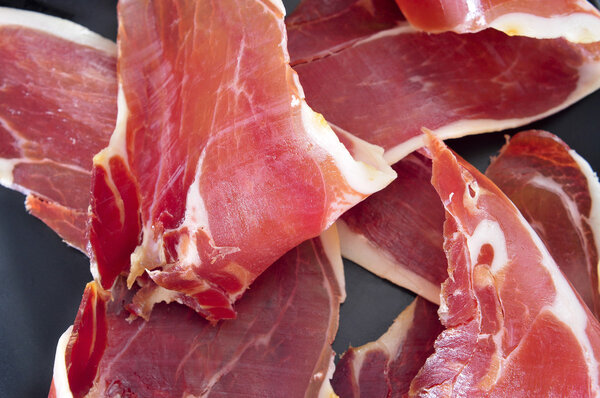Closeup of a pile of spanish serrano ham