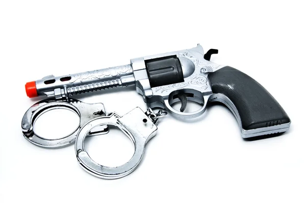 Spielzeugpistole und Handschellen — Stockfoto