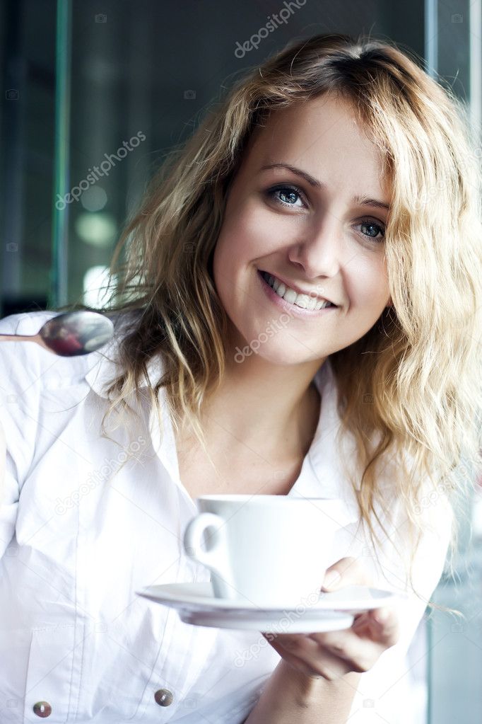 Beautiful woman in street cafe ,with cup