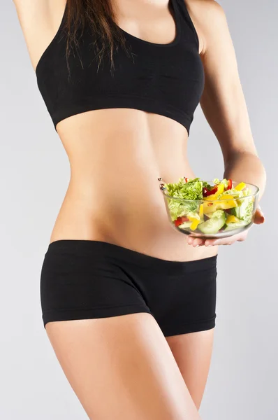 Woman with salad isolated on grey — Stock Photo, Image