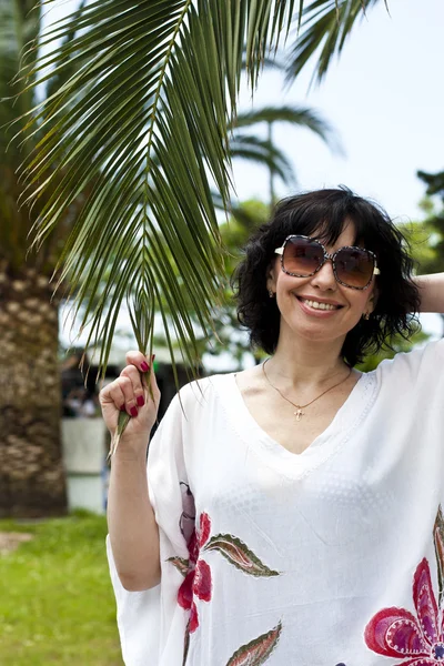 Woman with palm. Summertime — Stock Photo, Image