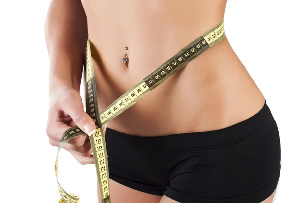 Thin young woman measures the waist — Stock Photo, Image