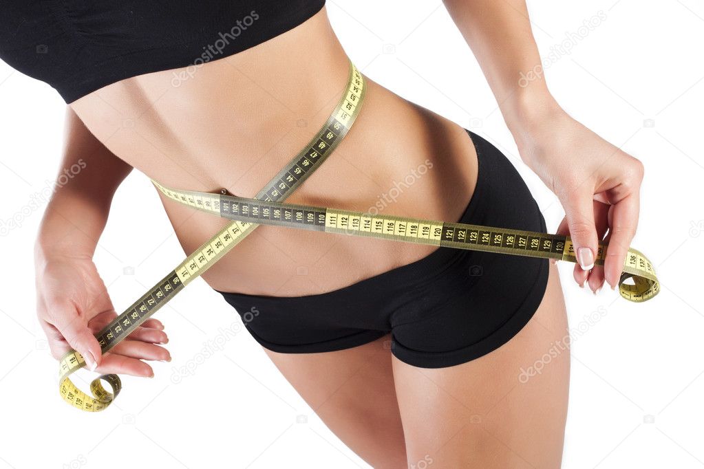 Thin young woman measures the waist