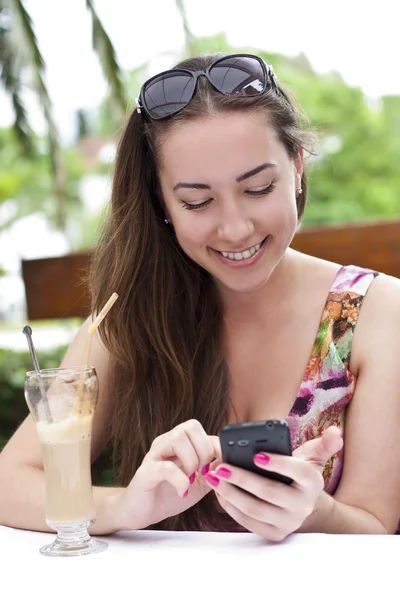 Menina sorridente bonita fala no telefone celular ao ar livre — Fotografia de Stock