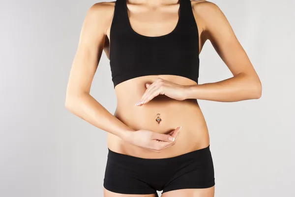 Woman's hands on stomach — Stock Photo, Image