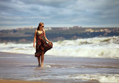 Young Caucasian woman at a beach clipart