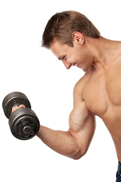 Muscular young man lifting a dumbbell — Stock Photo, Image