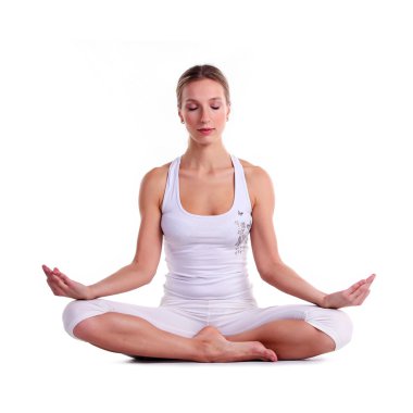 Young woman practicing yoga, sitting in a lotus position clipart