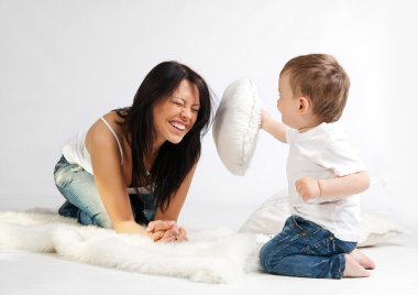 Young woman and her son having fun together clipart