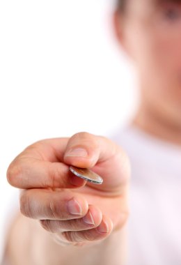 Young caucasian man holding a two euro coin. Image with shallow depth of field. The coin is in focus. clipart