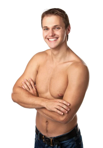 Netter lächelnder junger Kerl in Jeans mit nacktem Oberkörper — Stockfoto