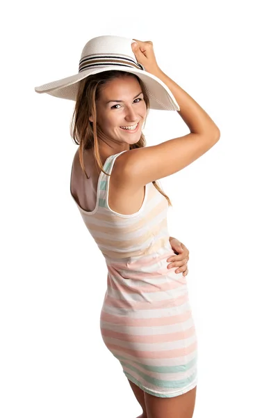 Smiling young woman in summer clothing and wearing a hat — Stock Photo, Image