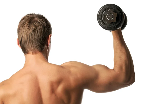 Muscular young man lifting a dumbbell, rear view — Stock Photo, Image