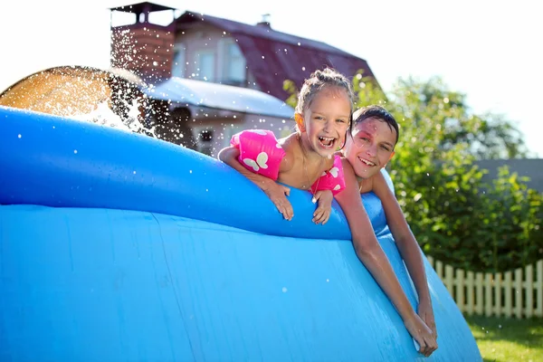 Crianças nadando em uma piscina inflável — Fotografia de Stock