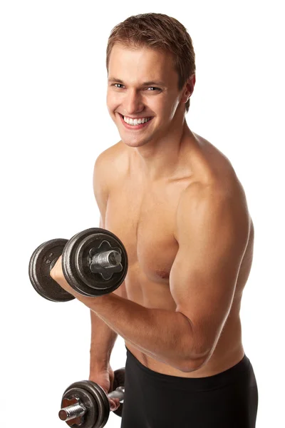 Muscular jovem levantando um haltere sobre fundo branco — Fotografia de Stock