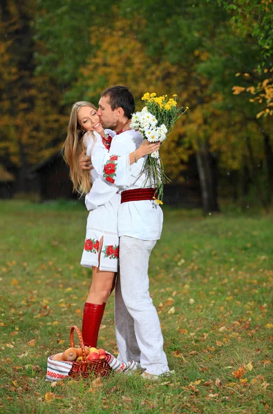 Young couple in Ukrainian style clothes outdoors — Stock Photo, Image