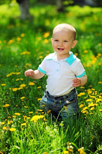 Portrait of a happy one-year old boy on a walk in a park — Stock Photo, Image