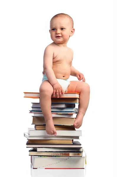 Portrait of a little boy sitting on a stack of books, isolated over white — Stock Photo, Image