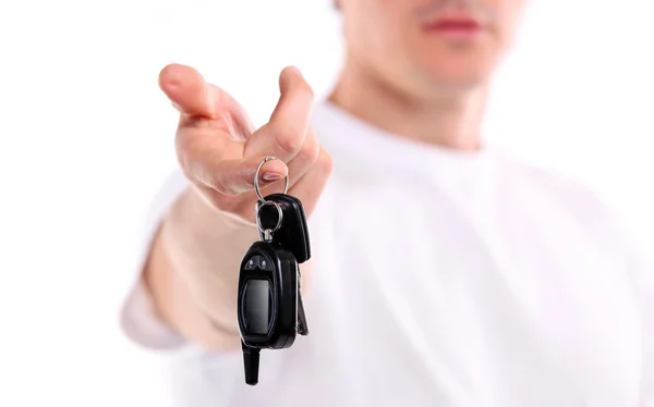 Young caucasian man holding car key. Image with shallow depth of field, the key is in focus. — Stock Photo, Image