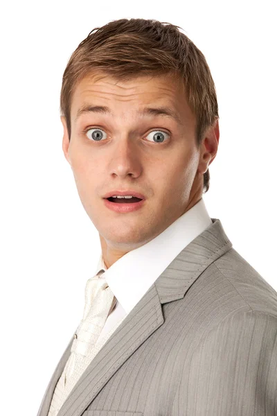 Portrait of a young man in a suit looking very shocked — Stock Photo, Image