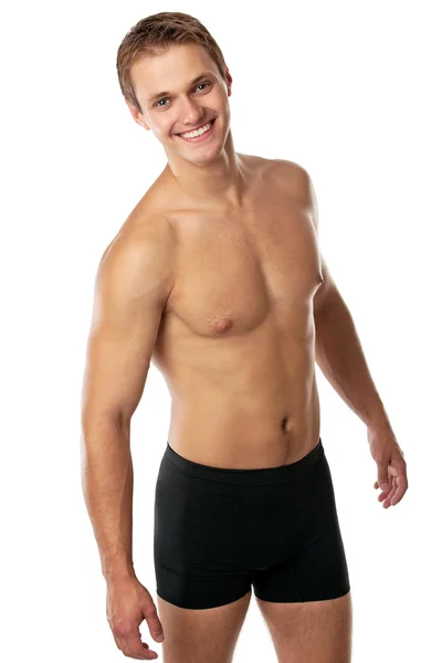 Cheerful young man in trunks over white background — Stock Photo, Image