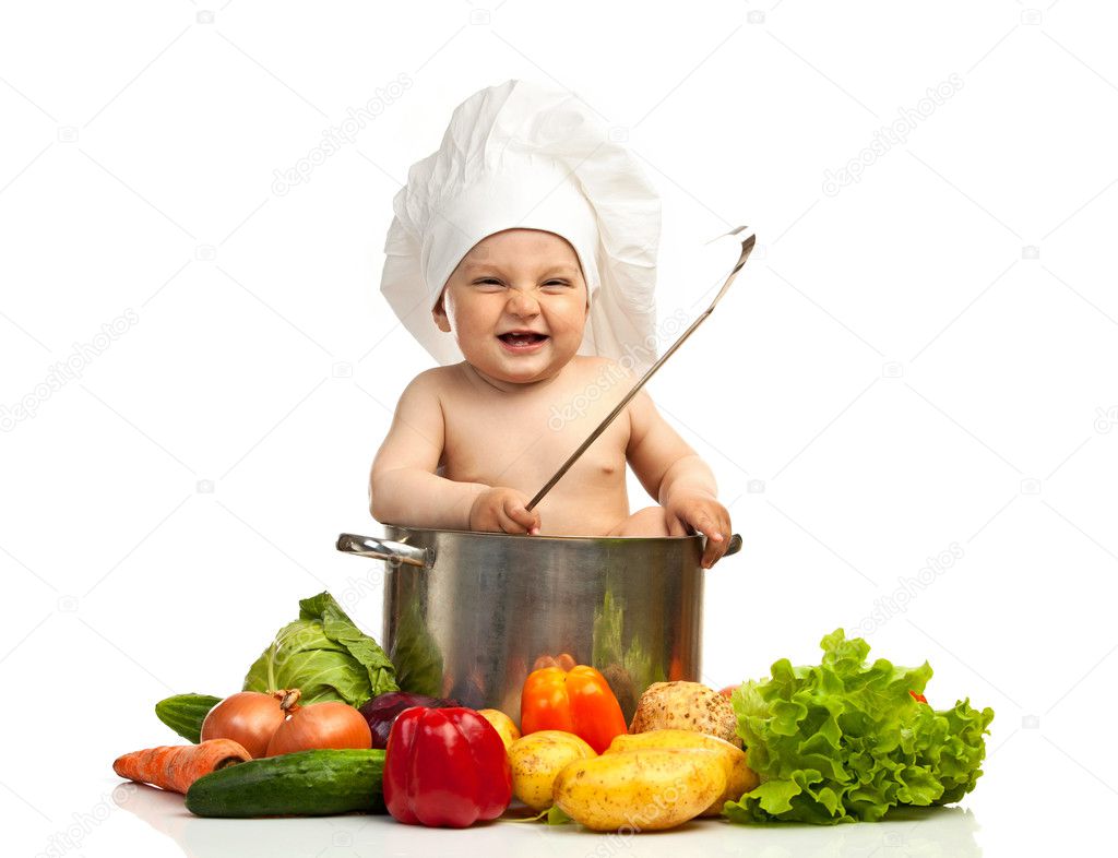 Little boy in chef's hat with ladle, casserole, and vegetables