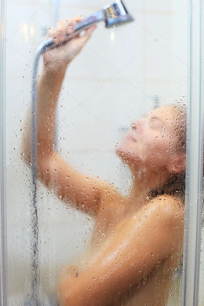 Young Caucasian woman taking a relaxing shower