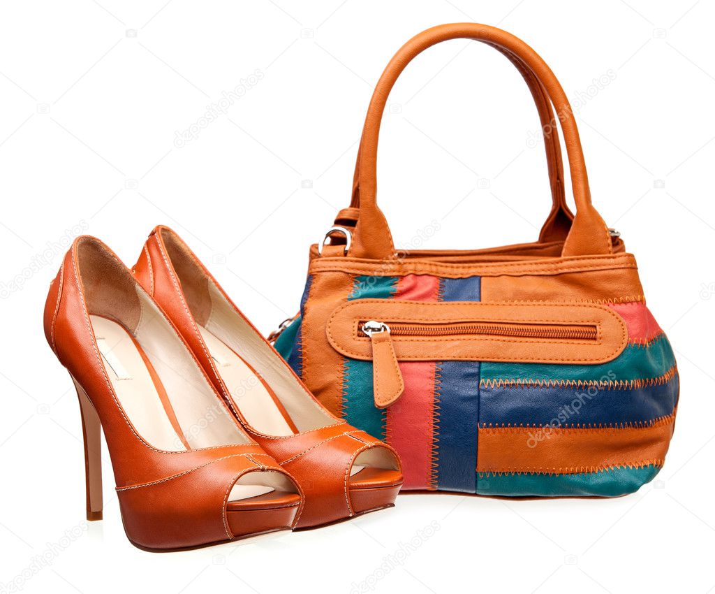 Pair of fashion women shoes and handbag over white