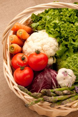 Basket full of vegetables: carrot, sparagus, tomato, chicory, ga clipart