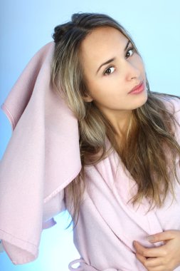 Young woman is drying her hair with a towel clipart