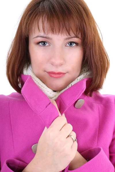 Cute woman in pink coat over white background — Stock Photo, Image