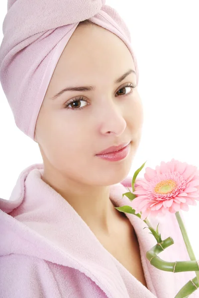 Young beautiful woman in bathrobe with gerberas and bamboo — Stock Photo, Image