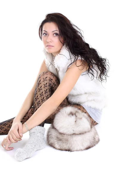 Beautiful woman with fur hat sitting — Stock Photo, Image