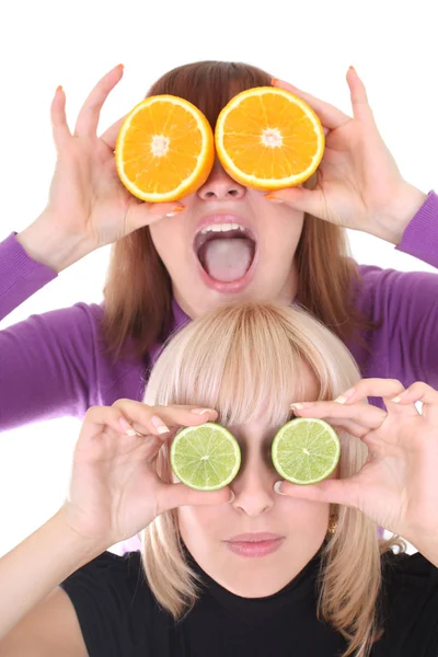 Two funny women with orange and lime slices instead of eyes — Stock Photo, Image