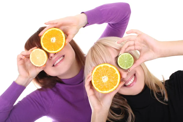 Two funny women with orange and lime slices instead of eyes — Stock Photo, Image