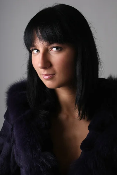 Portrait of young woman in fur coat — Stock Photo, Image