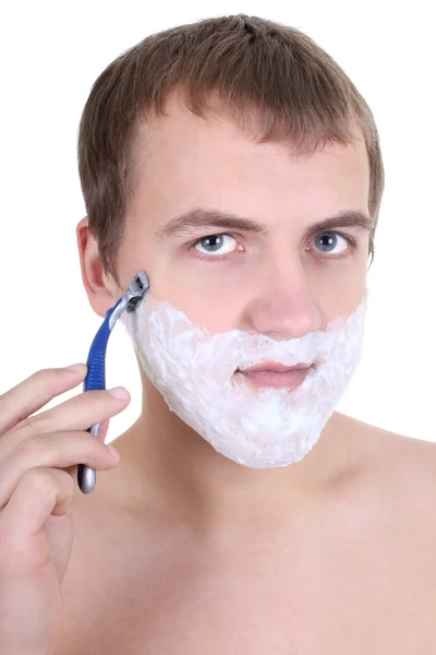 Молодий чоловік голиться з бритвою — стокове фото