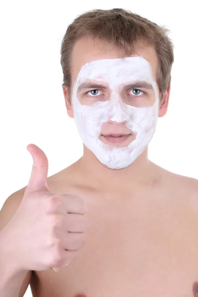 Junger Mann mit kosmetischen Maske auf seinem Gesicht-Daumen hoch — Stockfoto