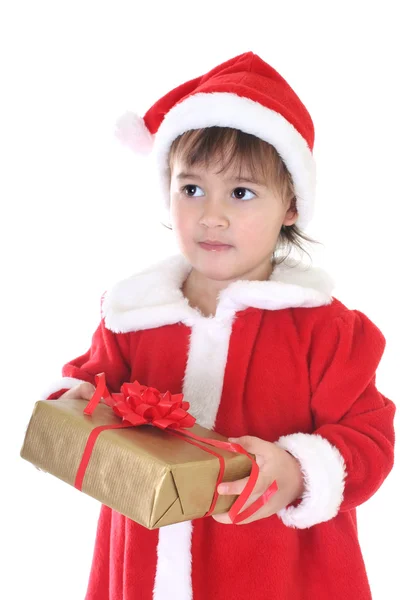 Garotinha com roupas de Papai Noel com presente — Fotografia de Stock