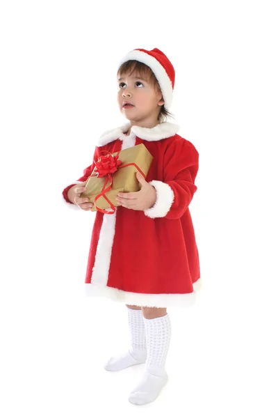Liten flicka i santa kläder med gåva — Stockfoto