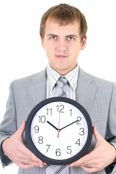 Mladý podnikatel drží hodiny — Stock fotografie