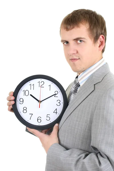 Mladý podnikatel drží hodiny — Stock fotografie