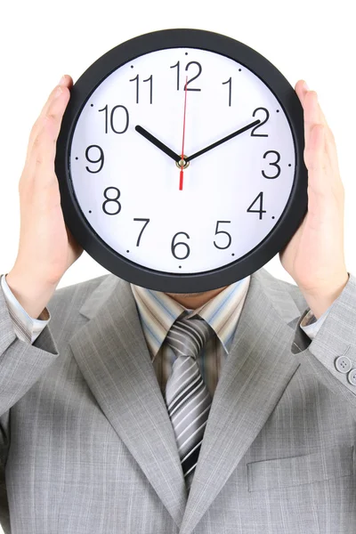 Hombre de traje gris sosteniendo un gran reloj cubriéndose la cara — Foto de Stock