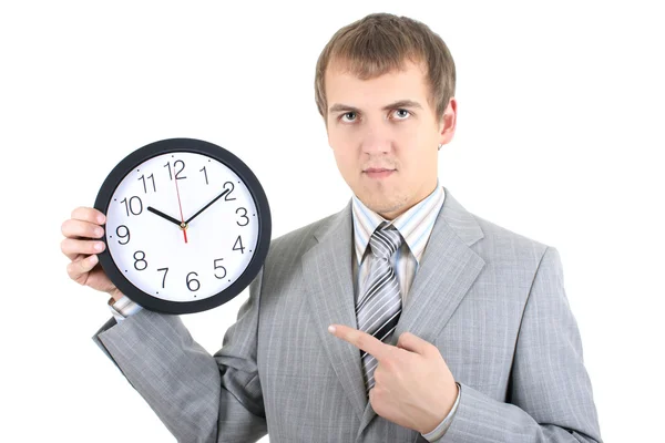 Young businessman holding a clock — Stock Photo, Image