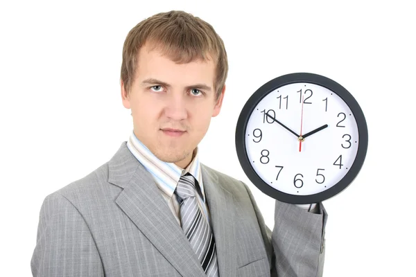 Ung affärsman innehar en klocka — Stockfoto