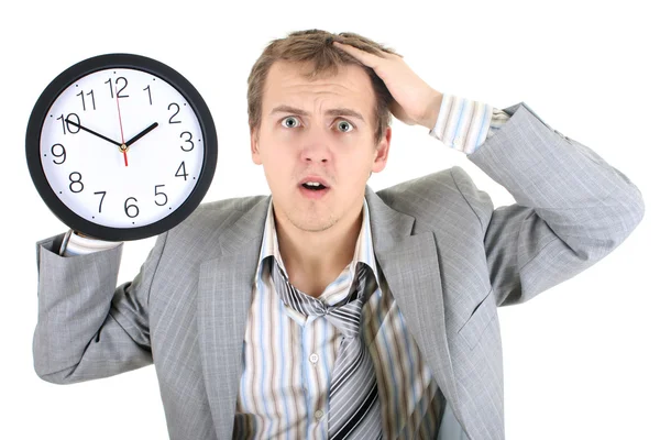 Förvånad affärsman i grå kostym innehar en klocka — Stockfoto
