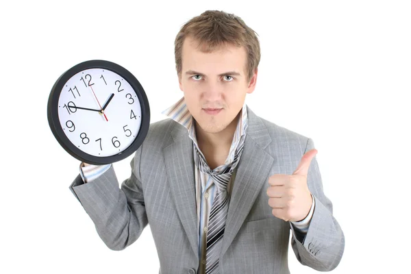 Happy businessman holding a clock — Zdjęcie stockowe