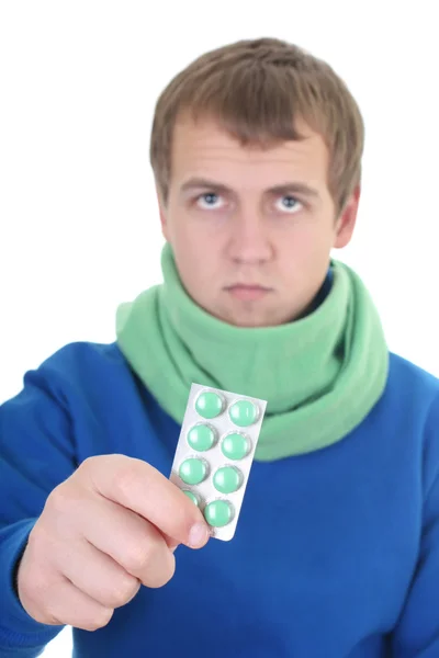 Junger Mann in blau mit Tabletten — Stockfoto