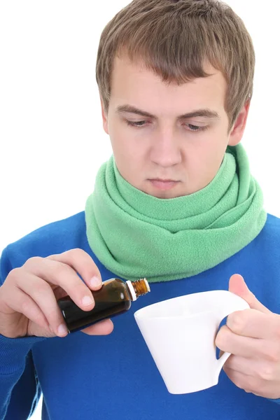 Ung man i blått med medicin och cup — Stockfoto