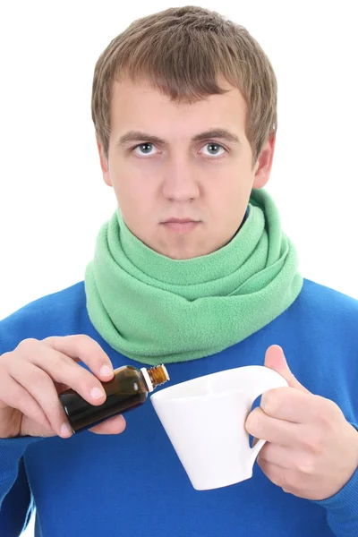 Junger Mann in blau mit Medizin und Tasse — Stockfoto